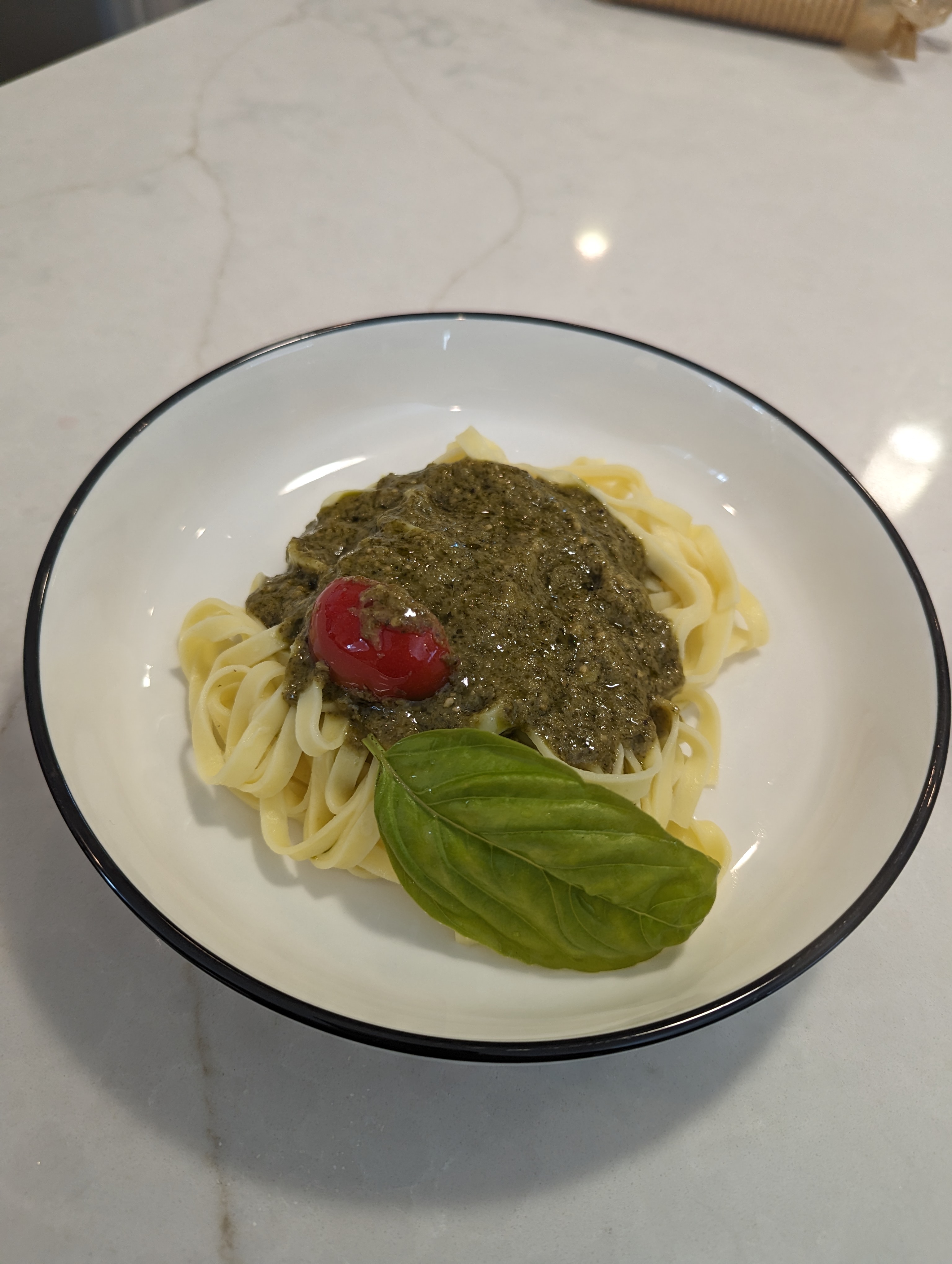 Pesto fettuccine with cherry tomato and basil